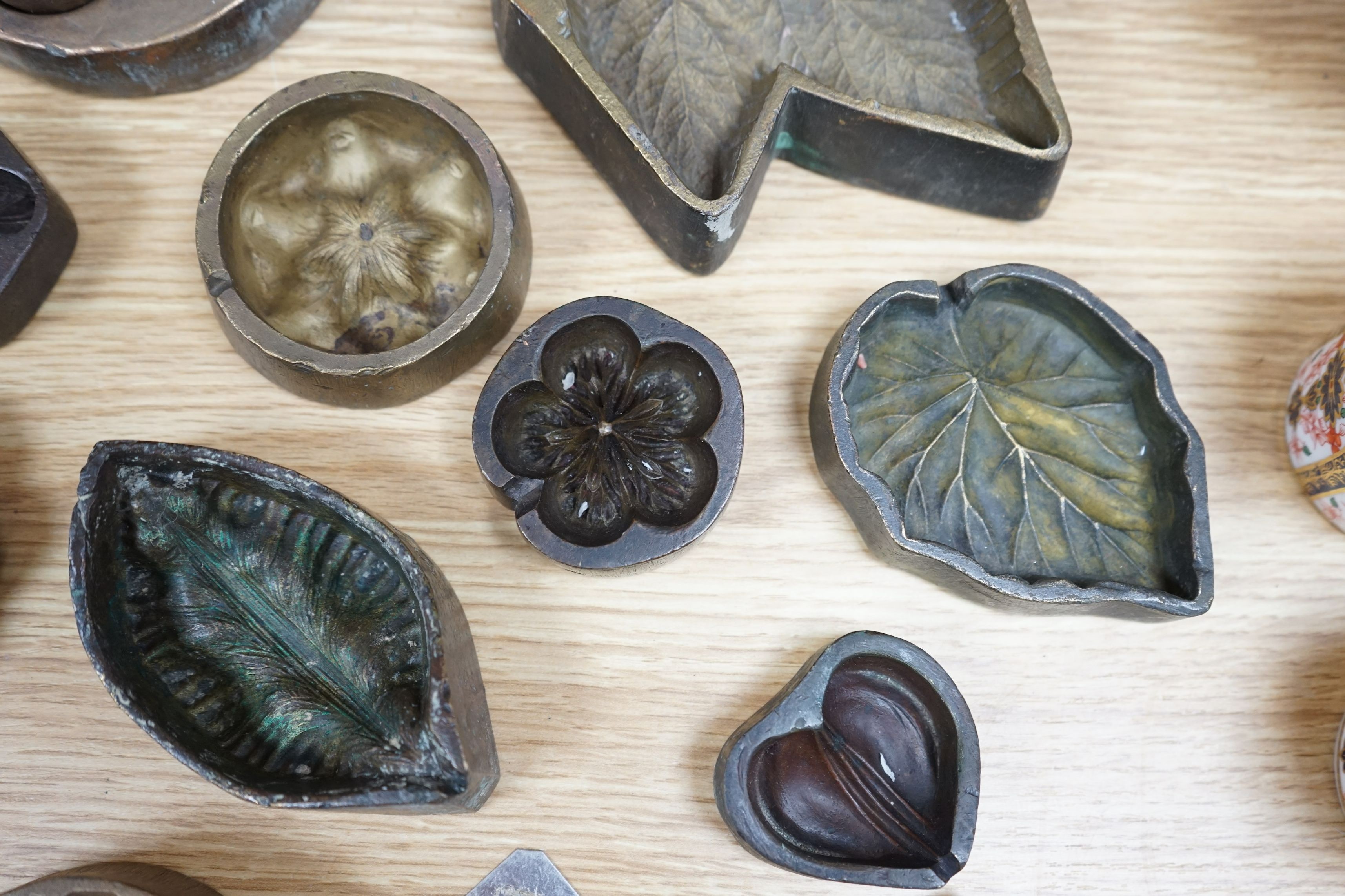 A collection of metal pattern moulds possibly for embossing silk (19) and two other moulds